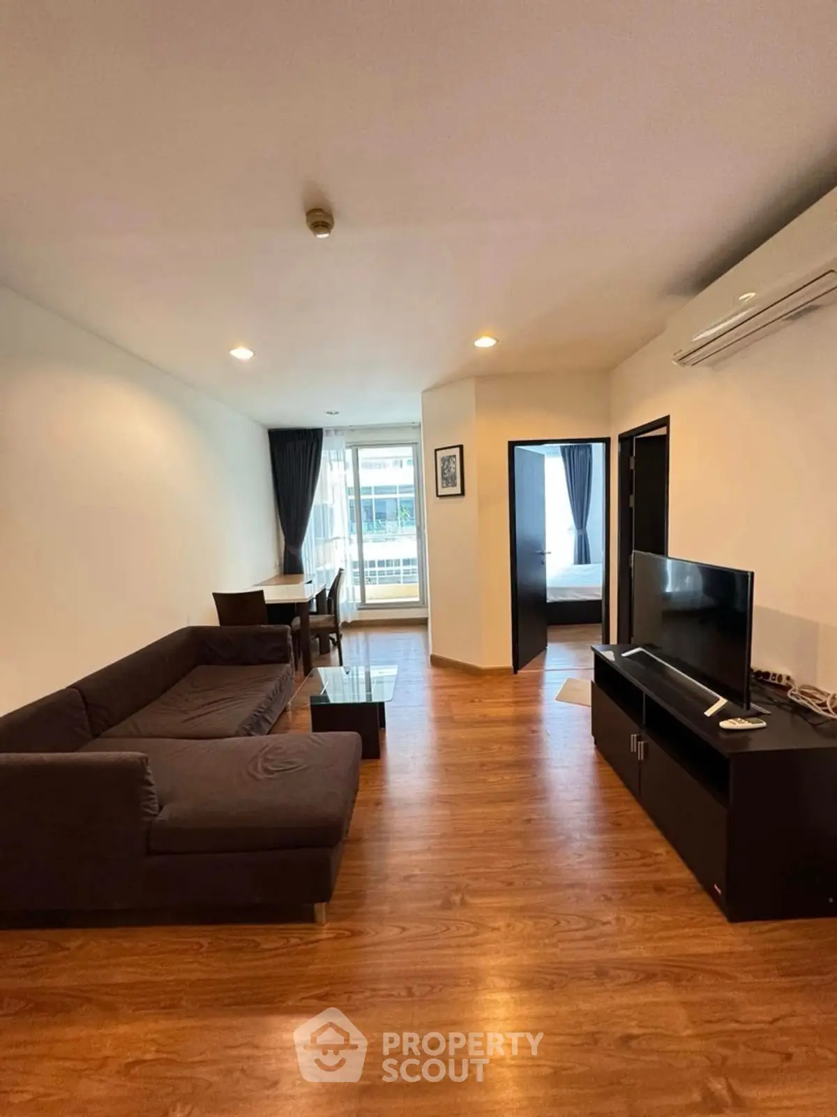 Spacious living room with modern furniture and wooden flooring