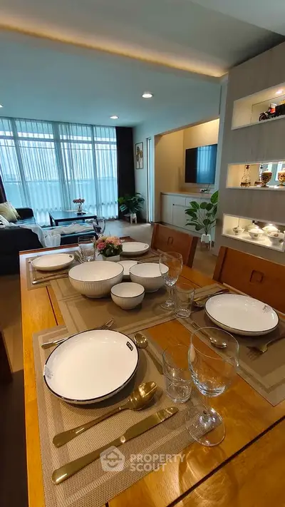 Elegant dining area with modern table setting and cozy living room ambiance.