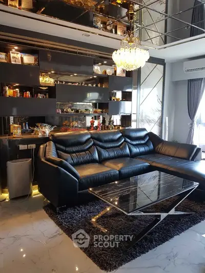 Luxurious living room with black leather sofa and elegant chandelier