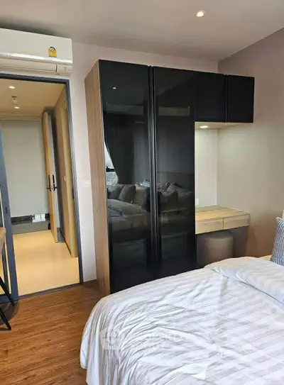 Modern bedroom with sleek wardrobe and cozy ambiance