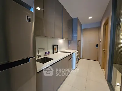 Modern kitchen with sleek cabinetry and integrated appliances in a stylish apartment.