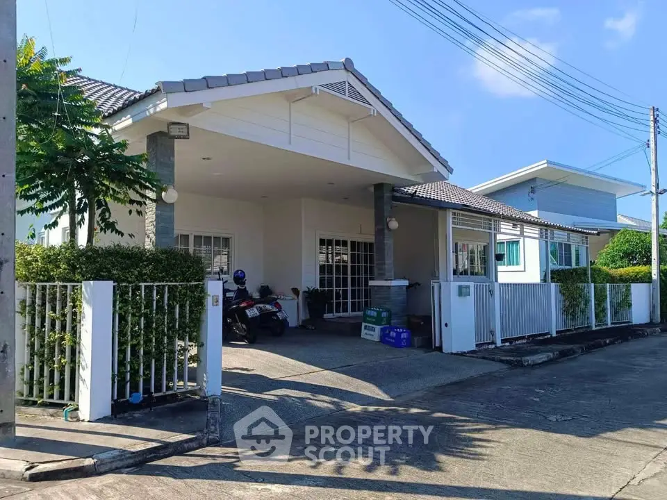 Charming suburban house with spacious driveway and lush greenery, perfect for family living.