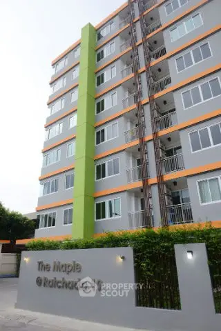 Modern apartment building with vibrant green accents and sleek design at The Maple Ratchada 19.