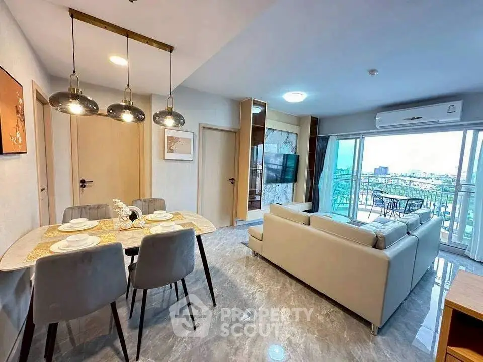 Modern open-plan living room with dining area and balcony view