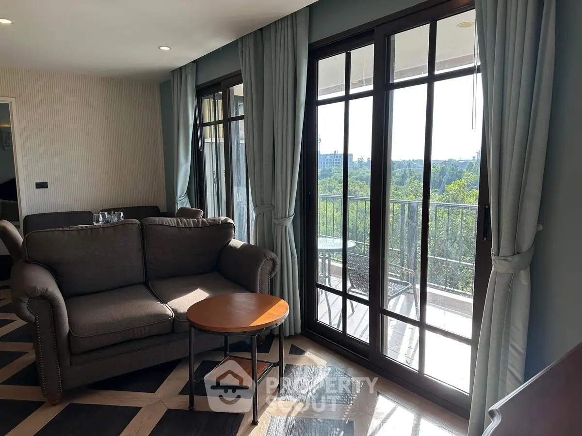 Spacious living room with large windows and balcony view