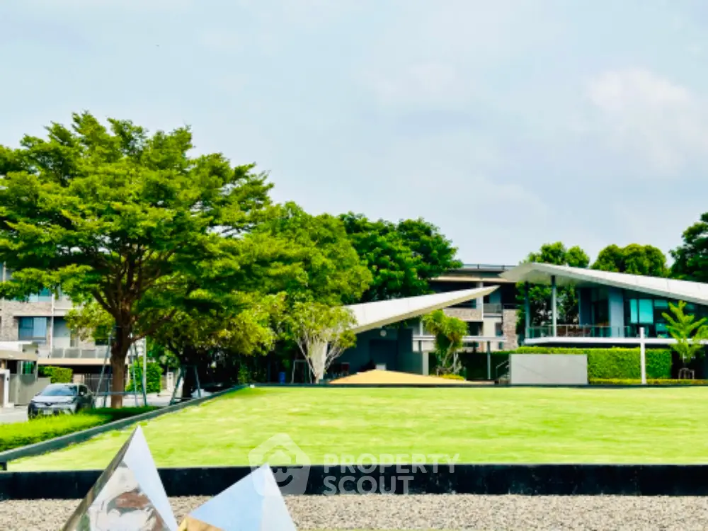 Modern architectural home with lush green lawn and contemporary design