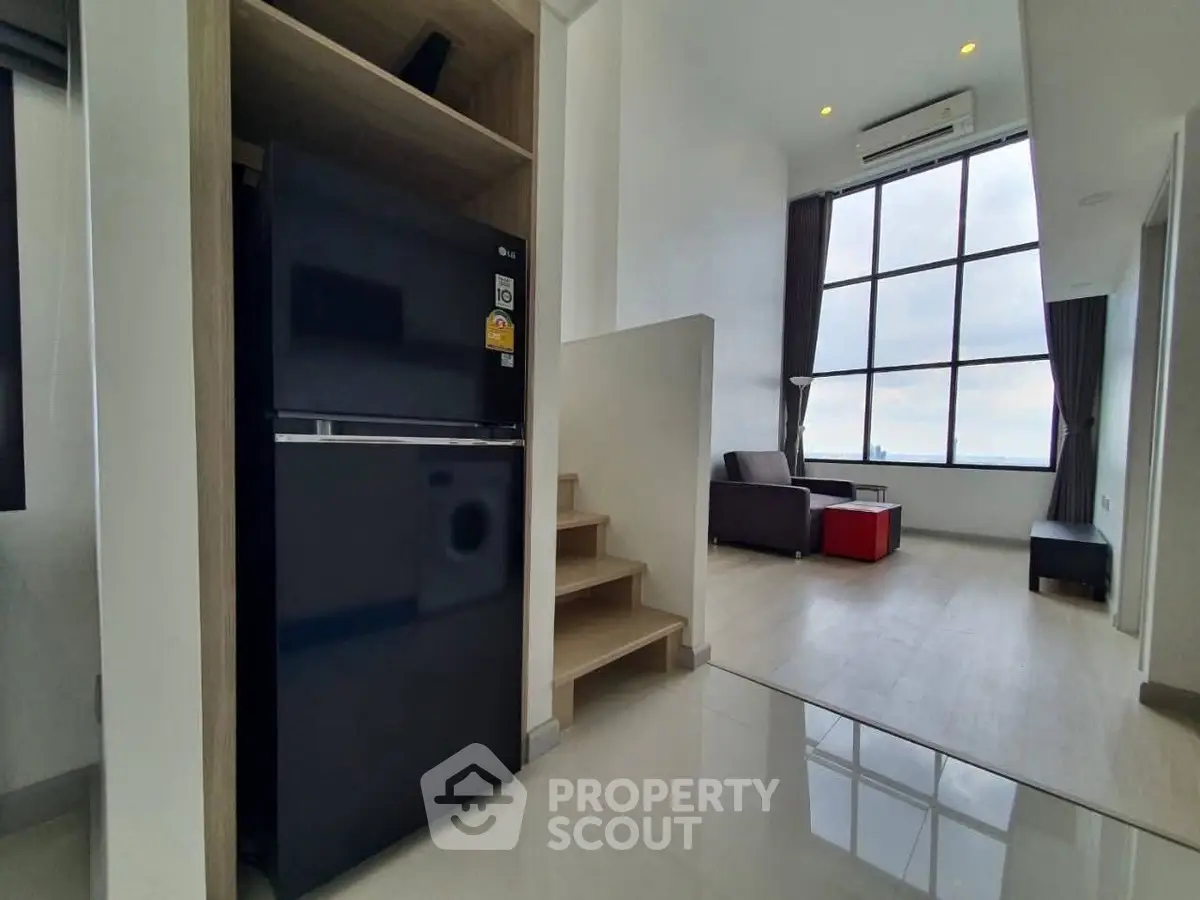 Modern duplex apartment with large windows and sleek interior design