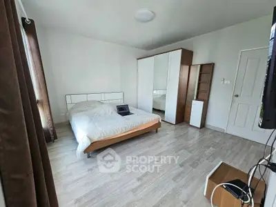 Spacious bedroom with modern furnishings and natural light