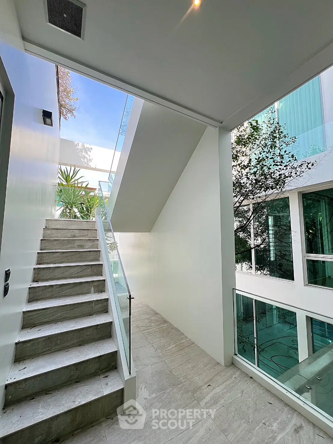 Modern building entrance with sleek staircase and glass railings