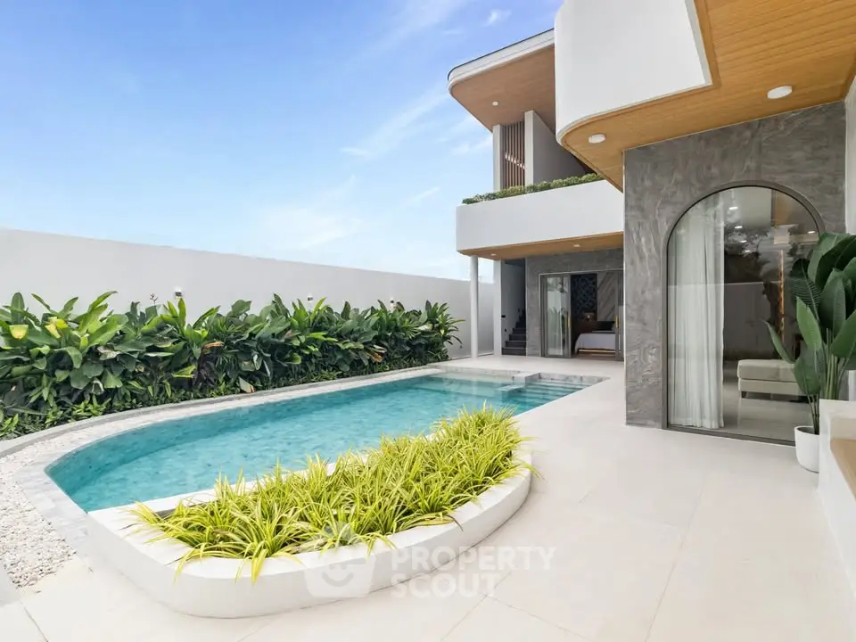 Luxurious modern villa with private pool and lush garden, perfect for relaxation and leisure.