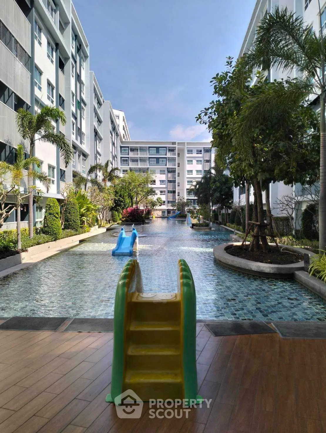 Luxurious apartment complex with stunning pool and lush landscaping