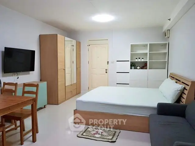 Cozy studio apartment with modern furnishings and ample storage space.