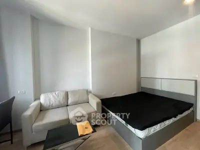 Modern bedroom with stylish sofa and sleek bed in a contemporary apartment.