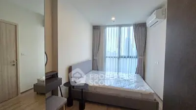 Modern bedroom with large window and air conditioning in a stylish apartment.