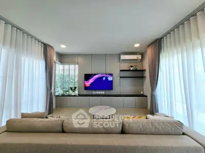 Spacious modern living room with large windows and elegant decor