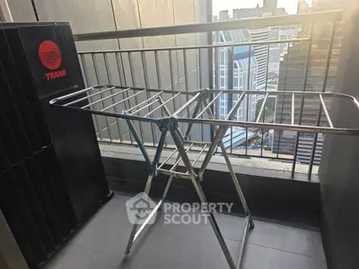 Modern balcony with city view and drying rack, ideal for urban living.