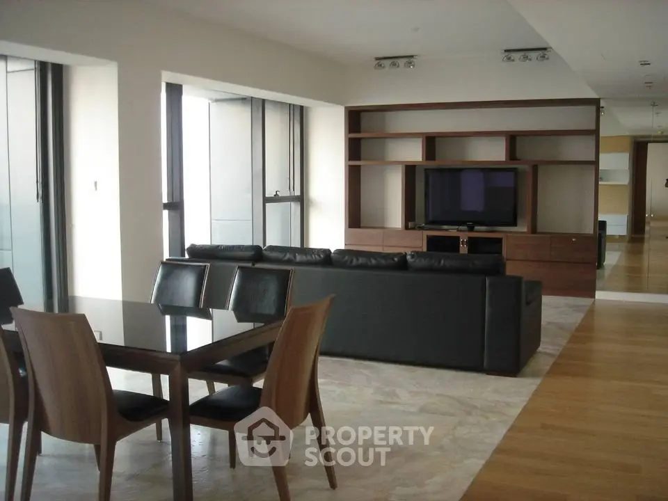 Spacious modern living room with sleek furniture and open layout in luxury apartment.