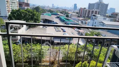 Urban balcony view overlooking cityscape and parking area