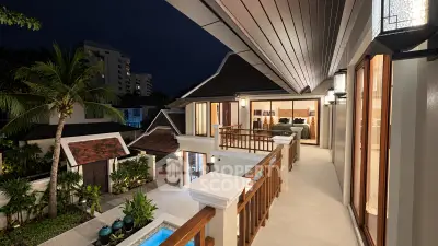Luxurious villa with spacious balcony and pool view at night