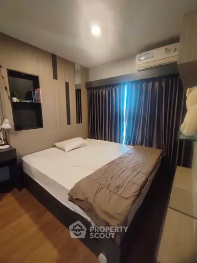 Cozy bedroom with modern decor and ample natural light, featuring a comfortable bed and stylish curtains.