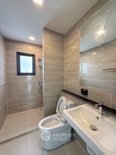 Modern bathroom with sleek tiles and walk-in shower