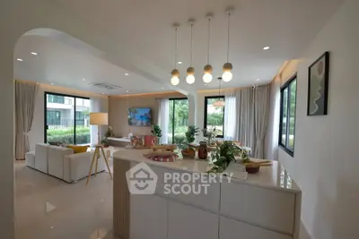 Modern open-plan living room with stylish decor and large windows