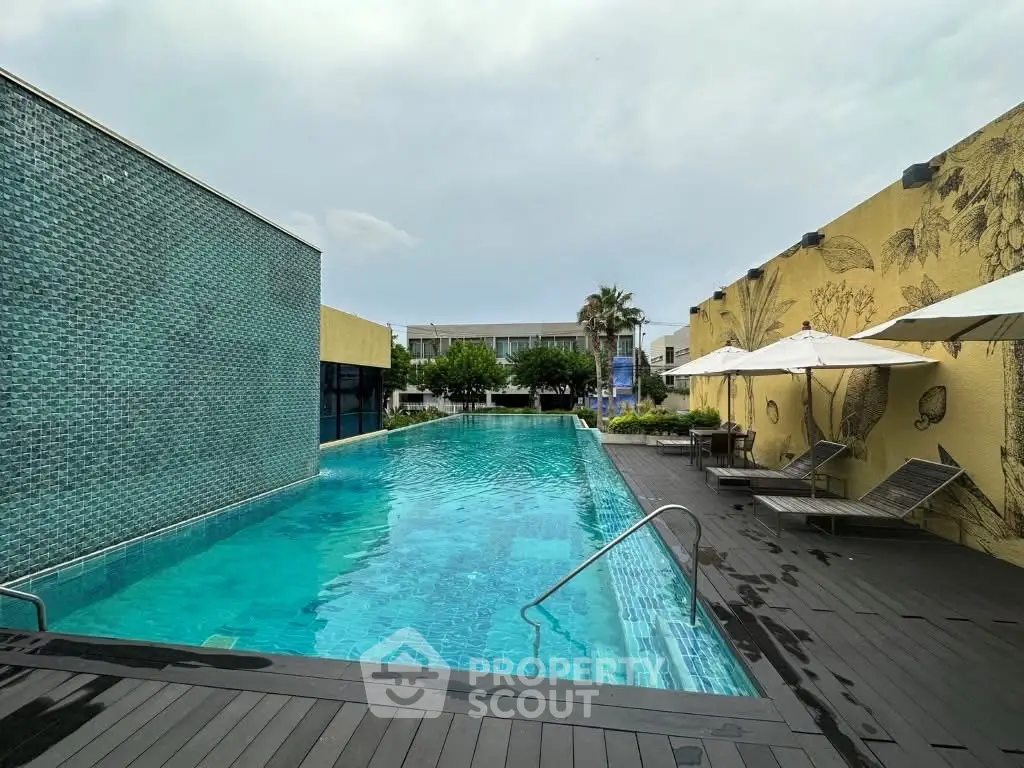 Luxurious outdoor pool area with modern design and stylish lounge chairs.