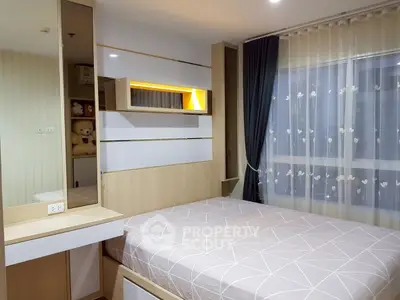 Modern bedroom with stylish decor and large window for natural light.