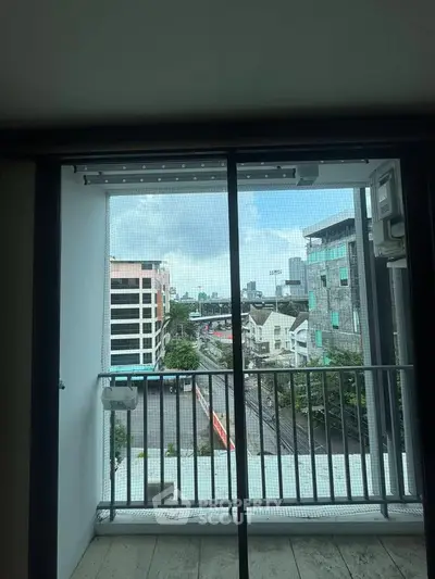 Urban view from a modern apartment balcony with cityscape and skyline.