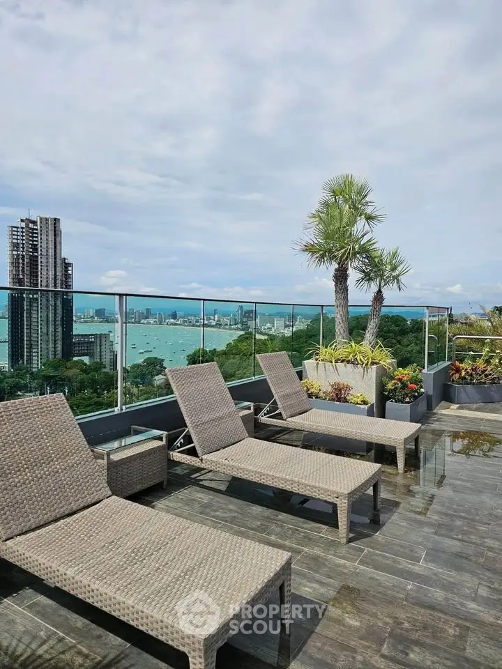 Luxurious rooftop with stunning ocean view and modern lounge chairs