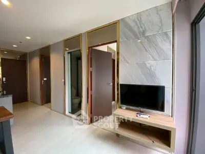 Modern apartment interior with sleek design and wall-mounted TV