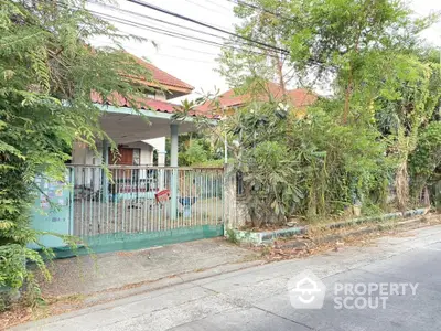 Charming single-story home with lush greenery and gated entrance, nestled in a tranquil neighborhood, offering a serene living experience.