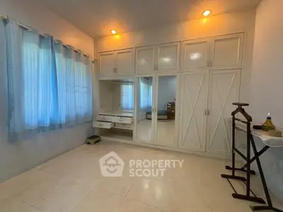 Spacious bedroom with built-in wardrobe and natural light