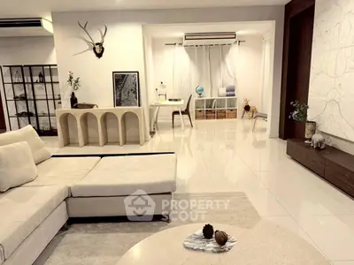 Spacious modern living room with elegant decor and cozy seating area, perfect for relaxation and entertainment.