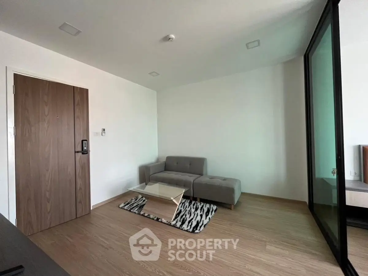 Modern minimalist living room with sleek grey sofa and stylish coffee table