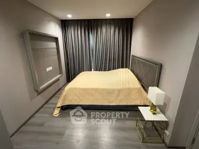 Modern bedroom with elegant decor and cozy ambiance, featuring a stylish bed and chic bedside table.