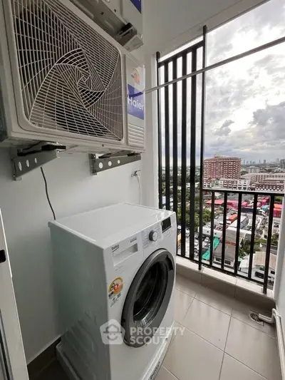 High-rise apartment balcony with washing machine and city view, perfect for urban living.