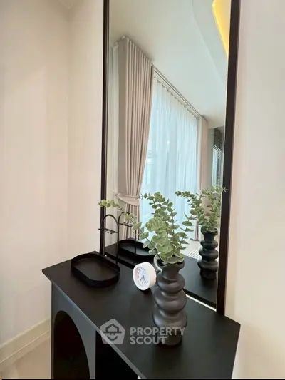 Elegant interior with modern decor and large mirror in a stylish living space.