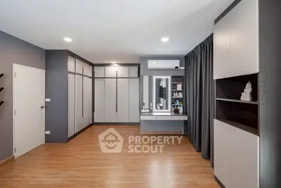 Spacious modern bedroom with sleek storage and vanity area