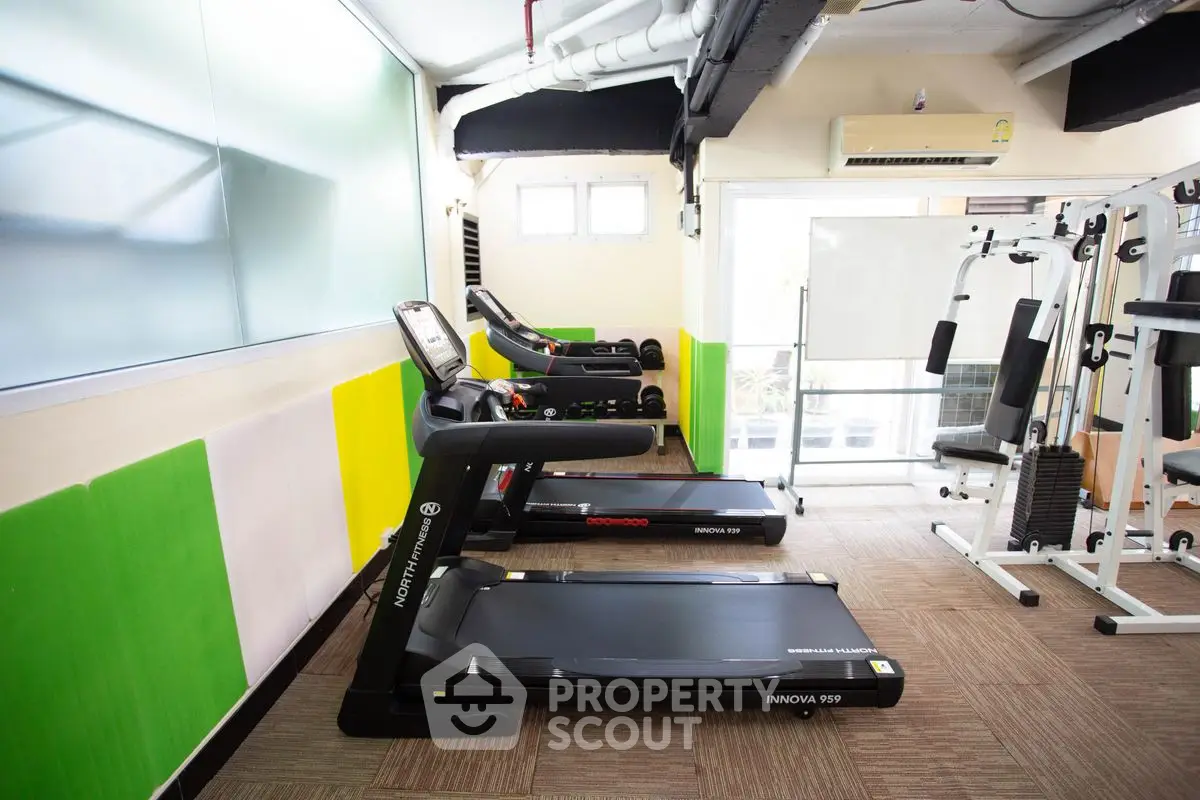 Modern gym with treadmills and fitness equipment in a bright, well-lit space.