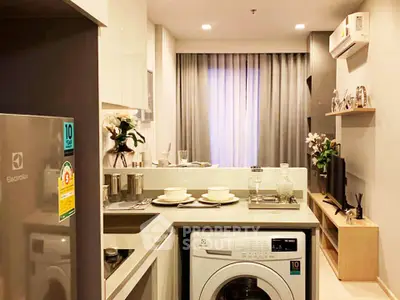 Modern compact kitchen with integrated washing machine and sleek appliances