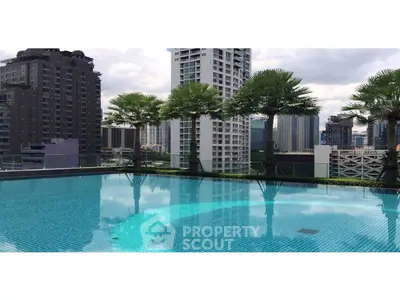 Luxurious rooftop pool with stunning city skyline view and palm trees