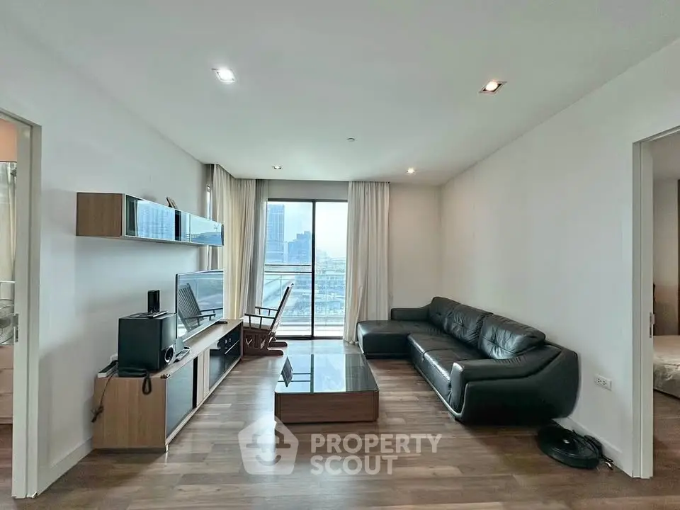 Modern living room with sleek furniture and city view balcony in luxury apartment