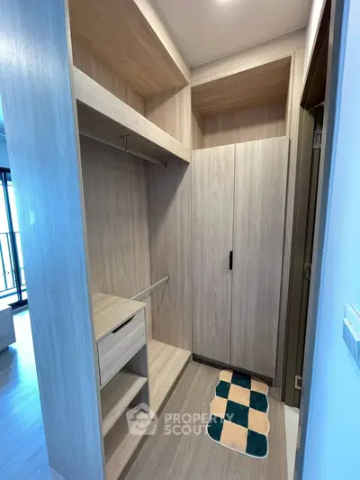 Spacious walk-in closet with modern wooden finish and ample storage space.