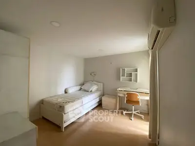Cozy bedroom with study area and air conditioning, ideal for students.