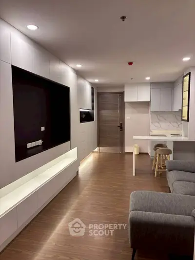 Modern living room with sleek design and open kitchen layout