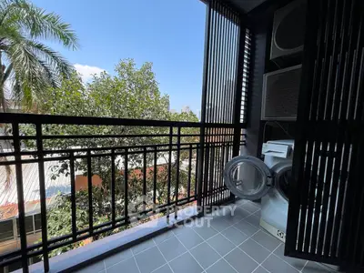Charming balcony with laundry area and scenic view, perfect for urban living.