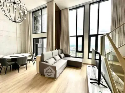 Luxurious modern living room with high ceilings and panoramic windows