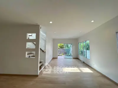 Spacious modern living room with large windows and natural light