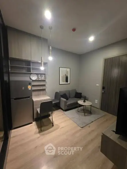 Modern living room with sleek furniture and stylish decor in a cozy apartment setting.